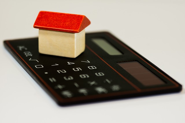 zabawkowy domek, ułożony na kalkutorze, ilutstruje artykuł dot. kredyt hipoteczny po rozwodzie